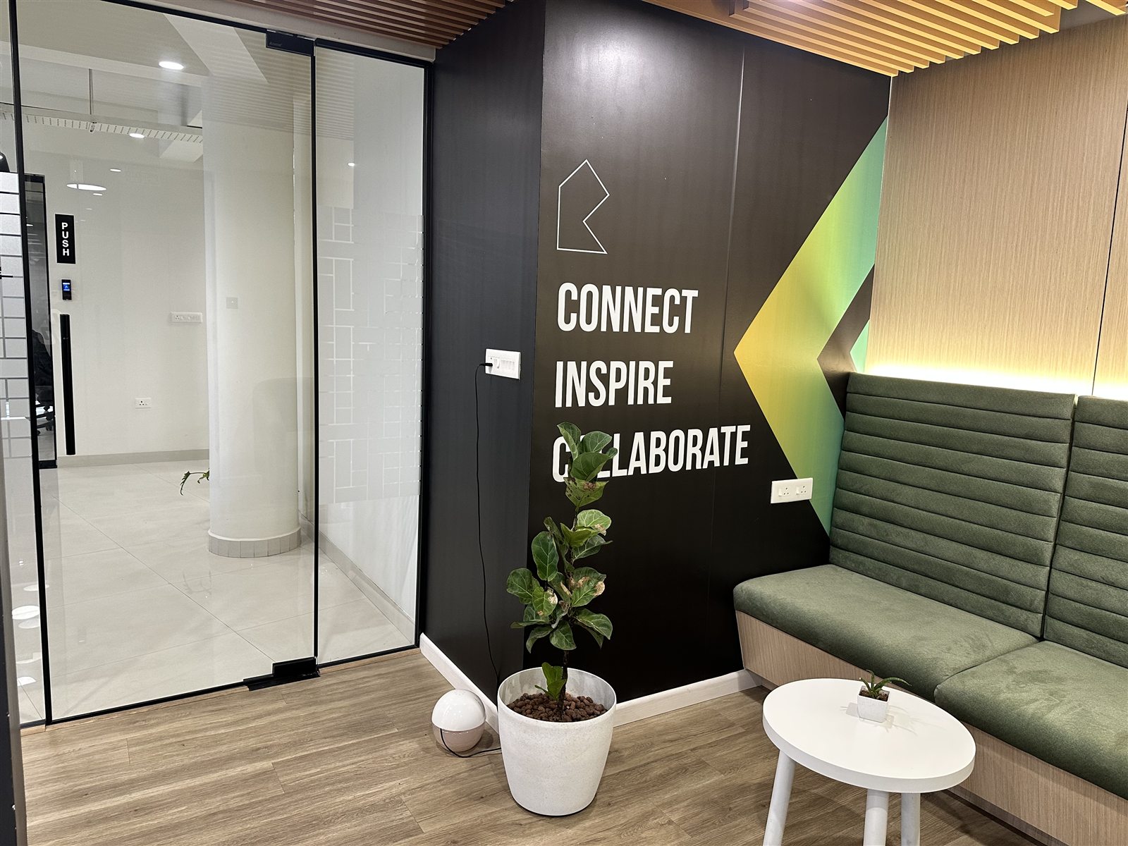 British Blitz office lounge with connect inspire collaborate wall